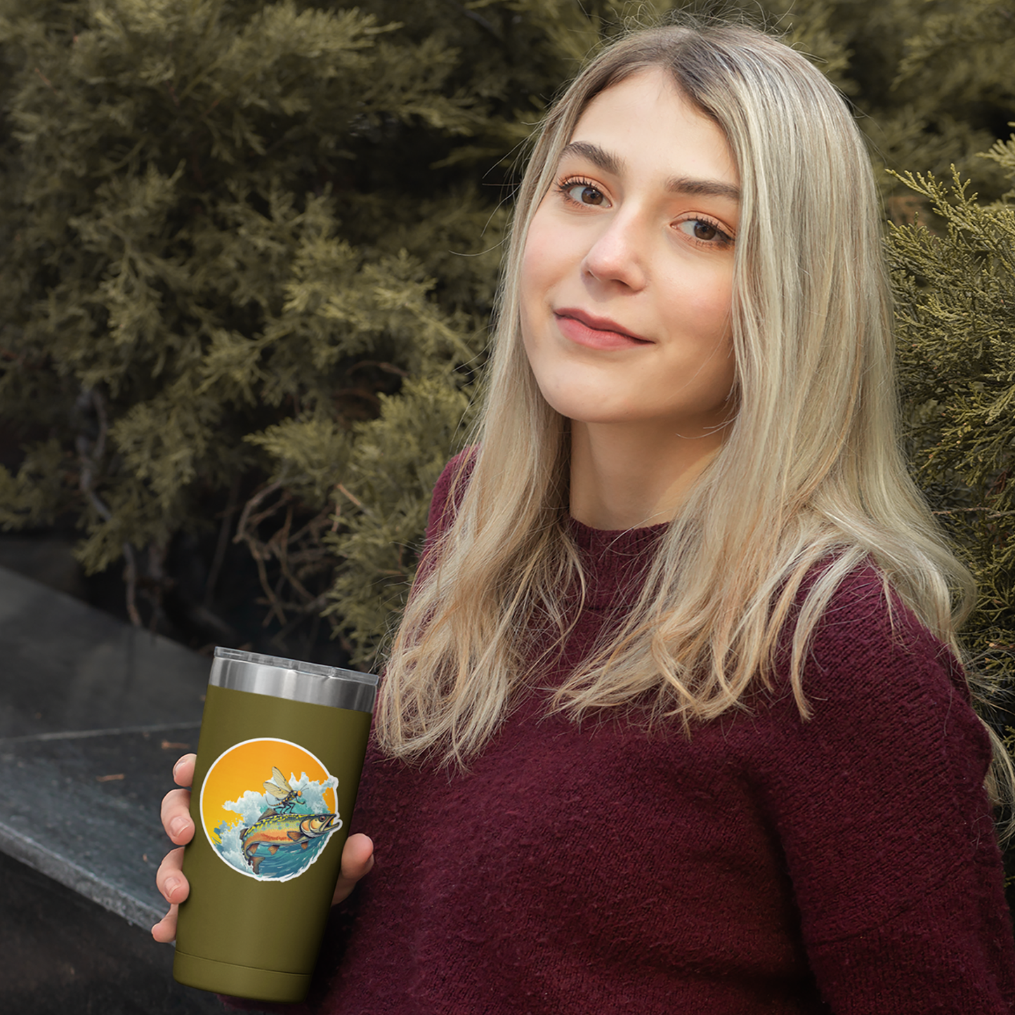 Picture of a women with a coffee mug that has a Headwater Canyon fly fishing decal.