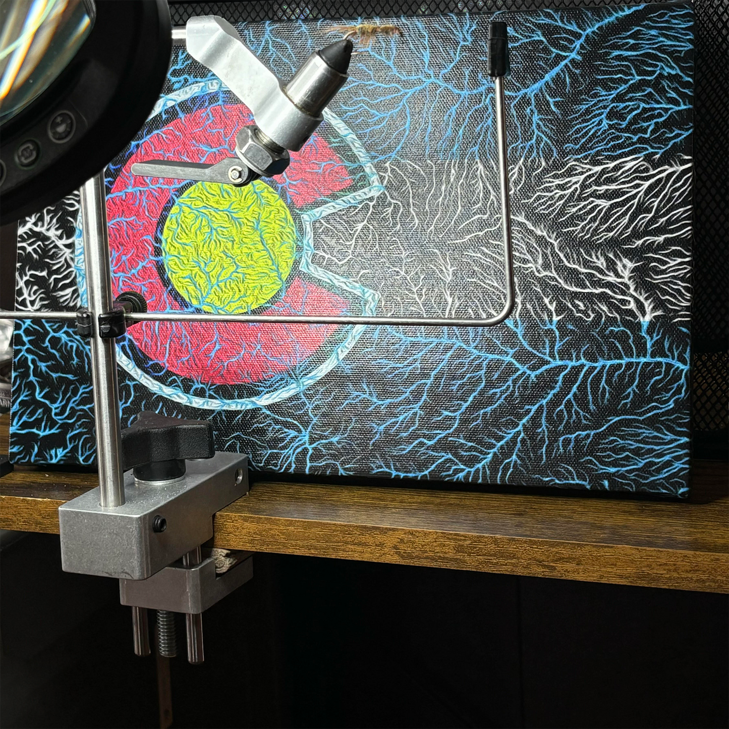 The Colorado Watersheds Canvas Wall Art by Headwater Canyon.  8" X 12" canvas behind a fly tying vice.