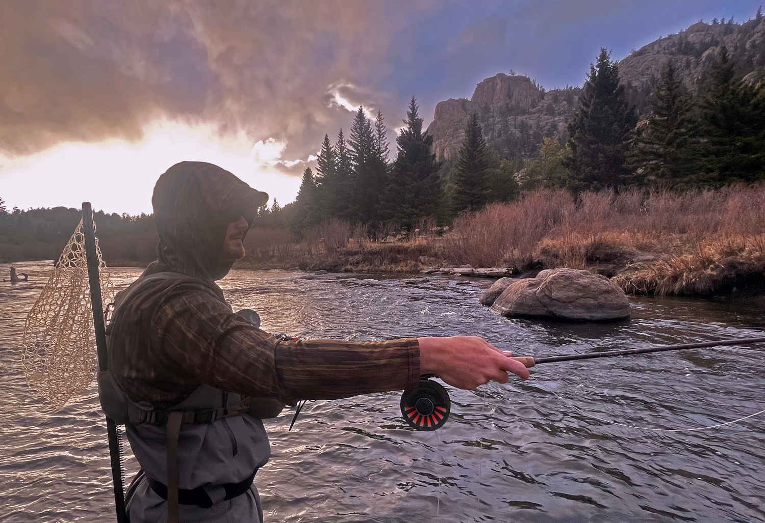 Man fly fishing Eleven Mile Canyon in a Headwater Canyon sun hoodie