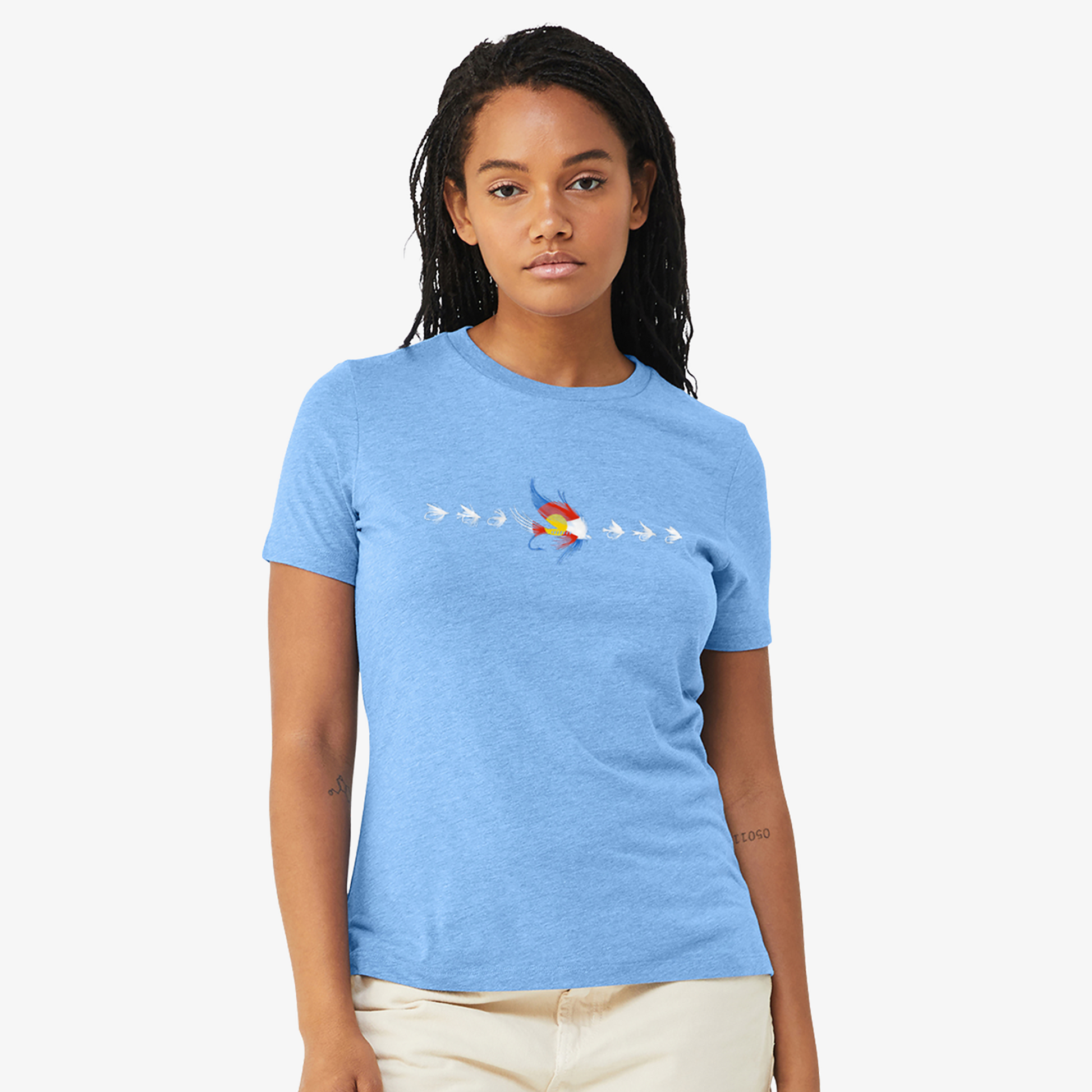Women's fly fishing t shirt.  Colorado blue colored women's tee.  The Fly CO Tee by Headwater Canyon.  Fly fishing shirt depicts a number of fishing flies with the Colorado flag colors on a woman model.