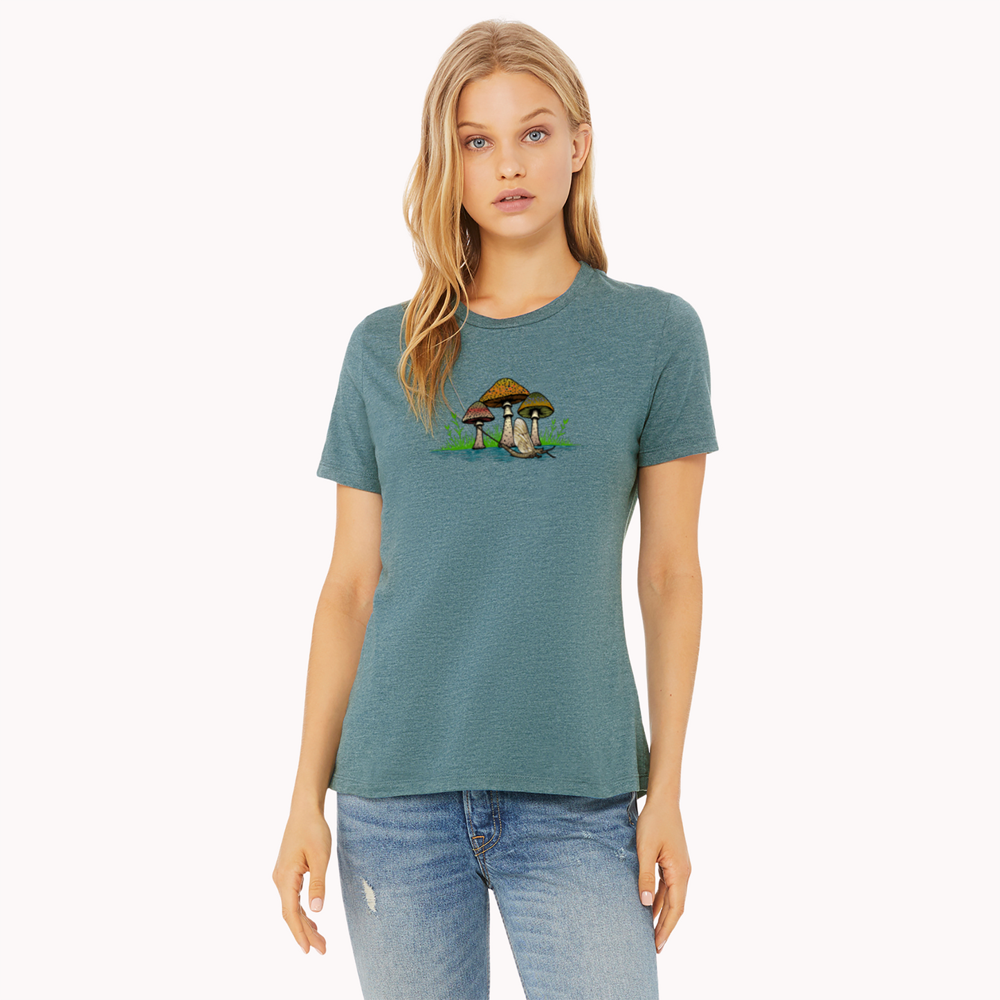 Women's fly fishing t shirt.  Deep Teal colored women's tee.  The Seems Fishy Tee by Headwater Canyon.  Fly fishing shirt depicts three mushrooms with trout patterns behind a mayfly on a woman model.