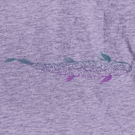 Close up of aWomen's fly fishing t shirt.  Lavender colored women's tee.  Trout is Fly Tee by Headwater Canyon.  Fishing flies form a trout.