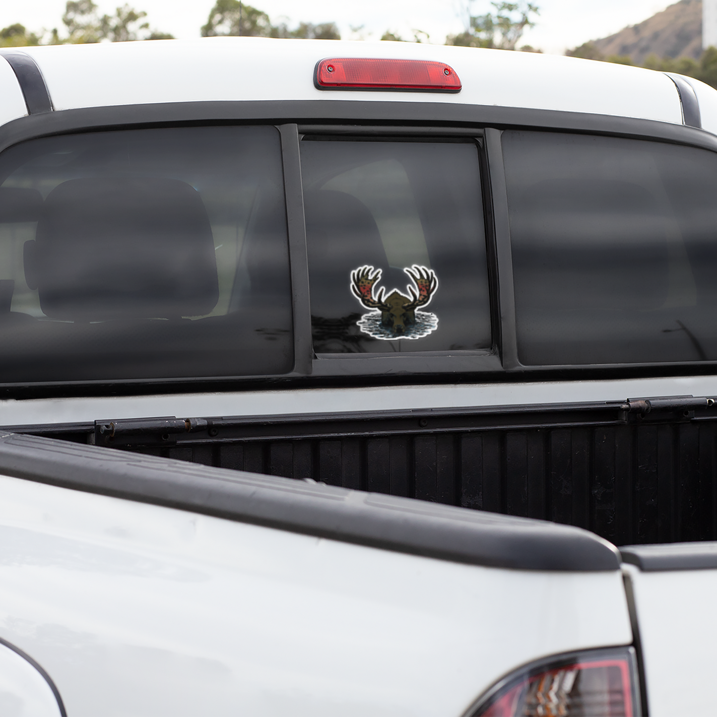 Fly fishing vinyl decal of  a moose with rainbow trout pattern.  Rainbull sticker on a truck window.