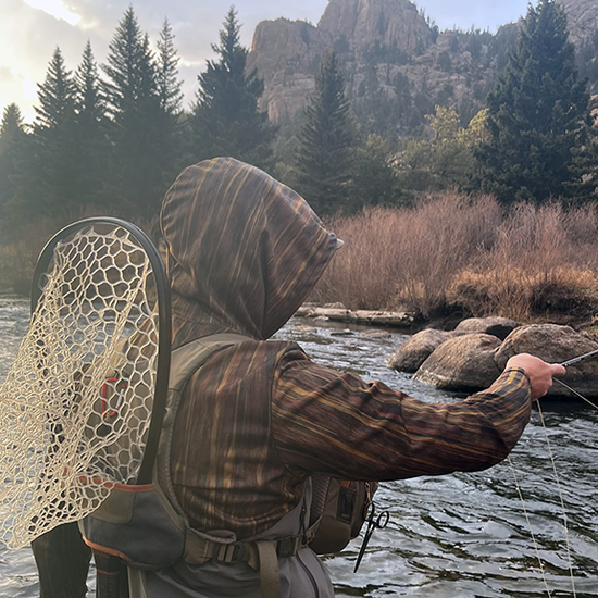 Man fishing at Eleven Mile Canyon in Headwater Canyon Sun Hoodie.  Performance USA made sun protection.  Canyon